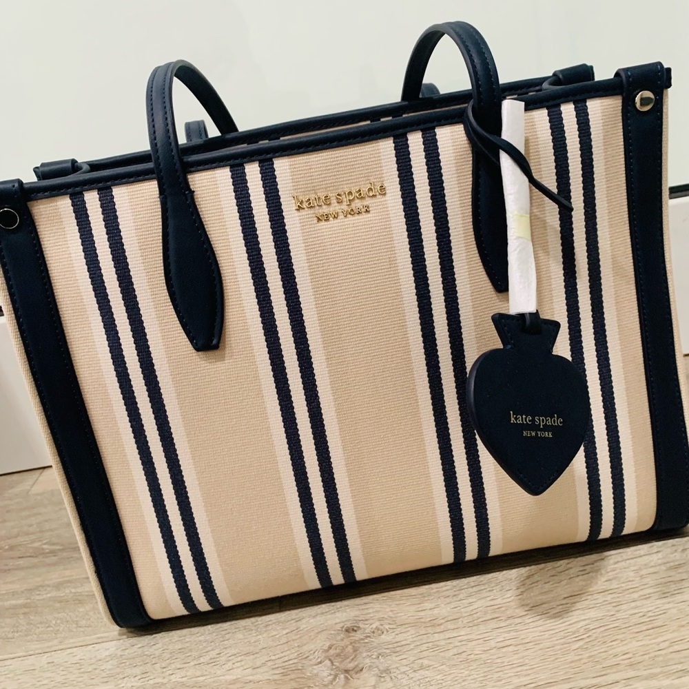 Sophisticated Kate Spade shoulder handbag. Navy, cream, and off white stripes.